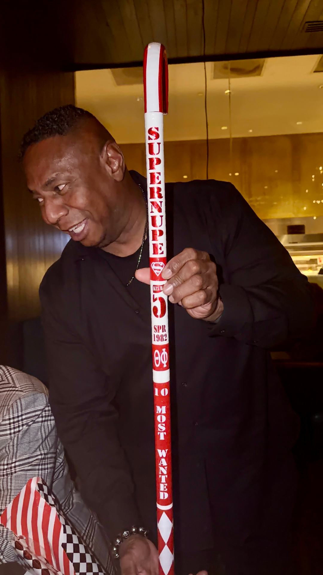Client with Supernupe 10 Most Wanted commemorative cane